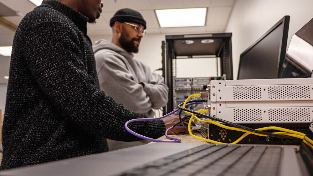 Two Helcim developers collaborate on project.