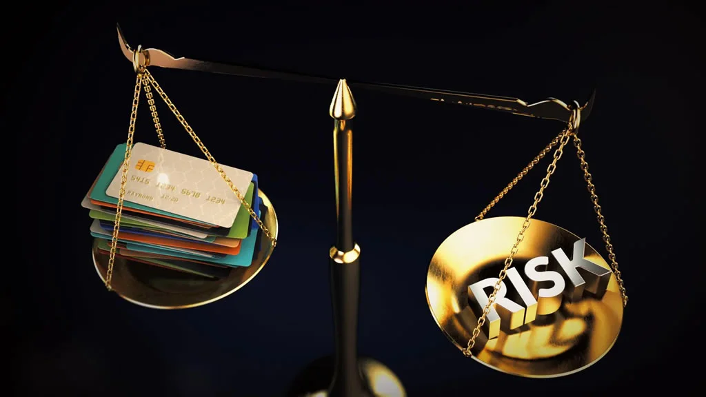Risk outweighing a stack of credit cards on a scale