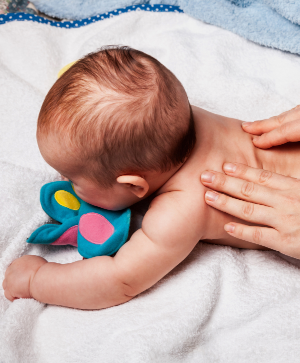 Chiropractor practices with baby