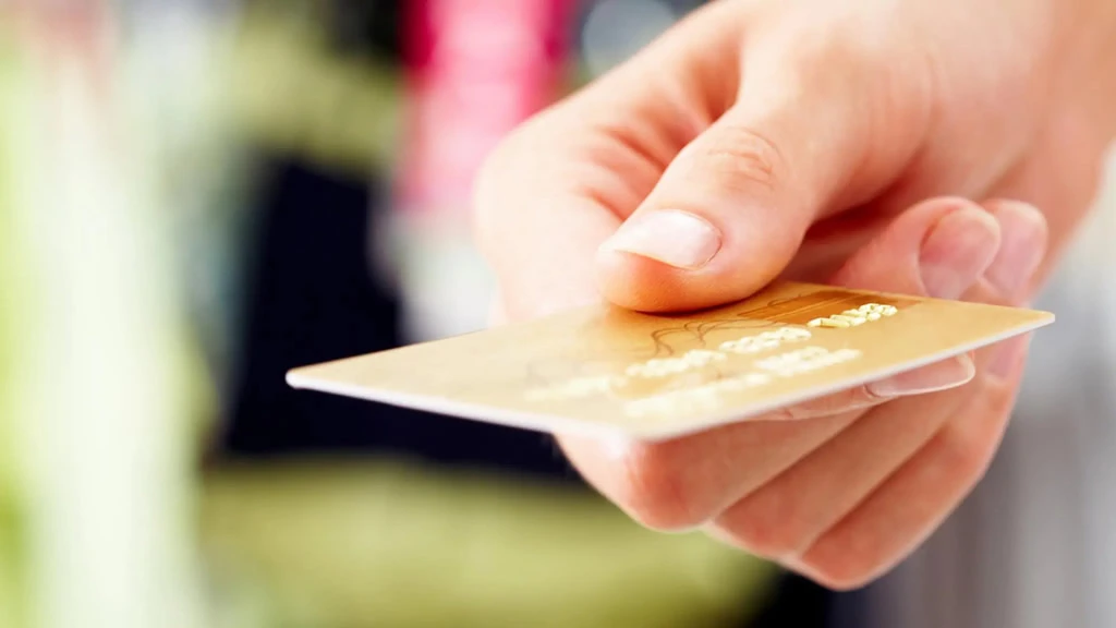 gold credit card being presented