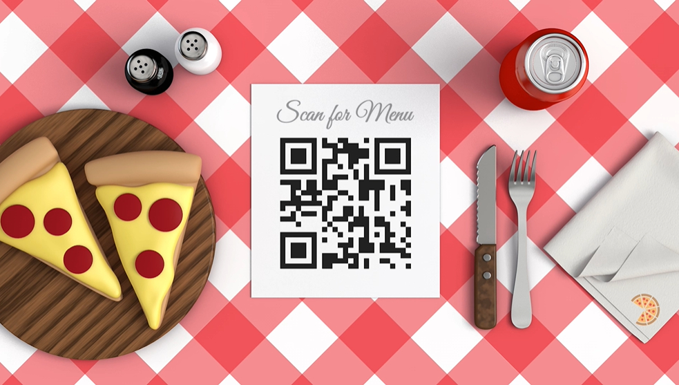 a table with pizza, a qr code, soda, cutlery and salt and pepper