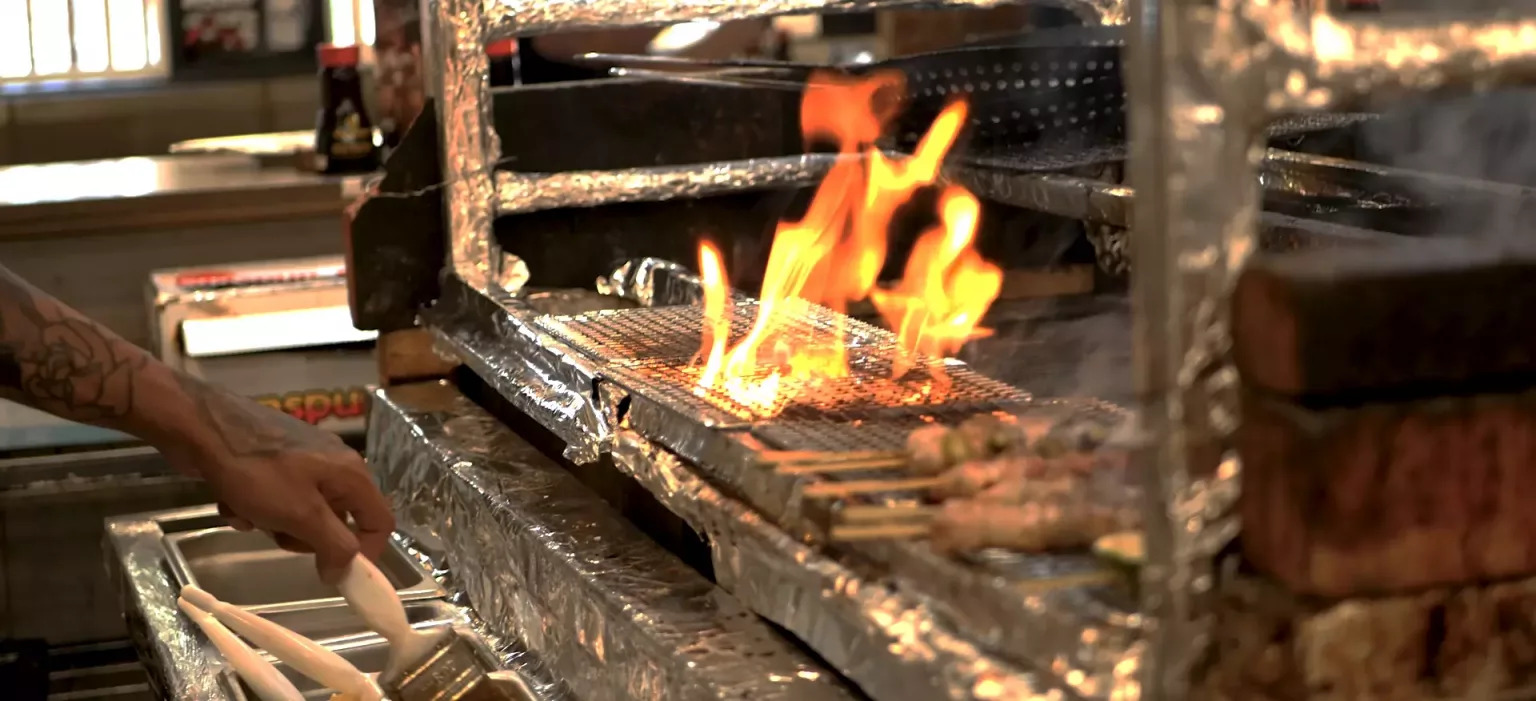 Ke Charcoal Grill and sushi - open grill with food being prepared