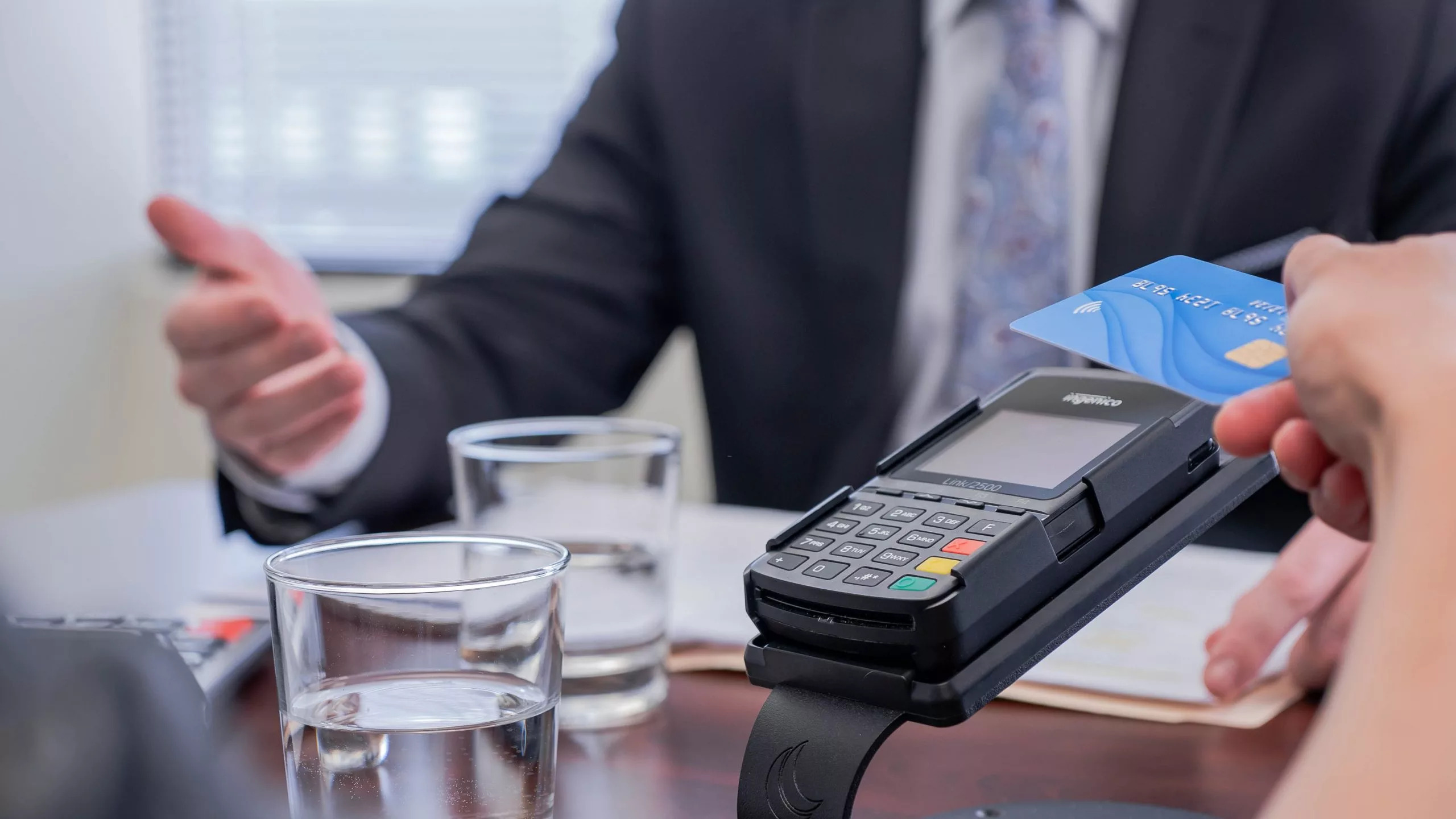 a lawyer talking with a client and a credit card stand on the desk