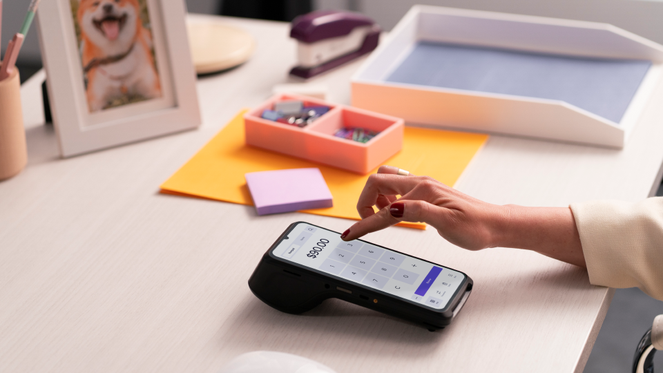 A person making an in-person credit card payment with the Helcim Smart Terminal