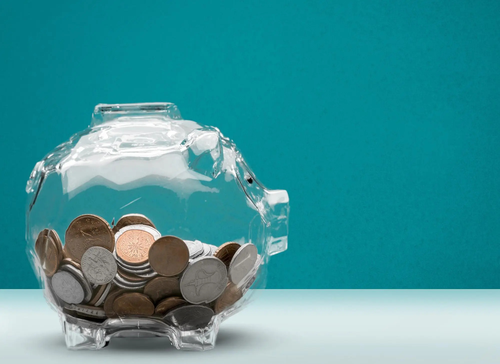 savings in a glass piggy bank